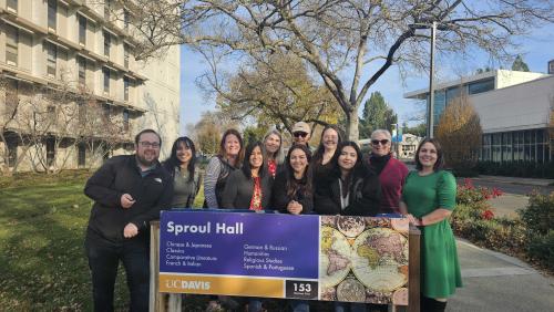 Languages & Literatures Staff Group Shot behind Sproul Hall sign