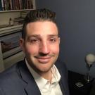 Man posing in front of bookshelf